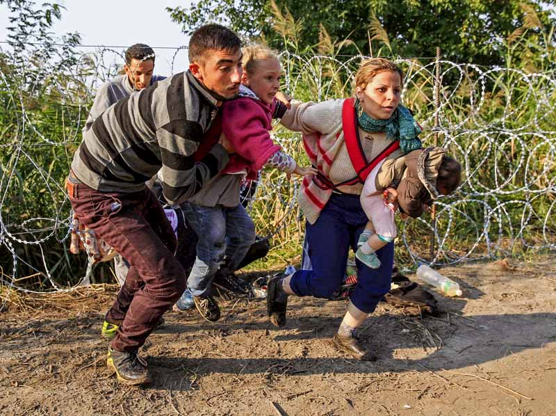 Internationella konventioner tillåter inget tak för antalet beviljade asylansökningar. Foto:Bernadett Szabo/Alamy Stock Photo